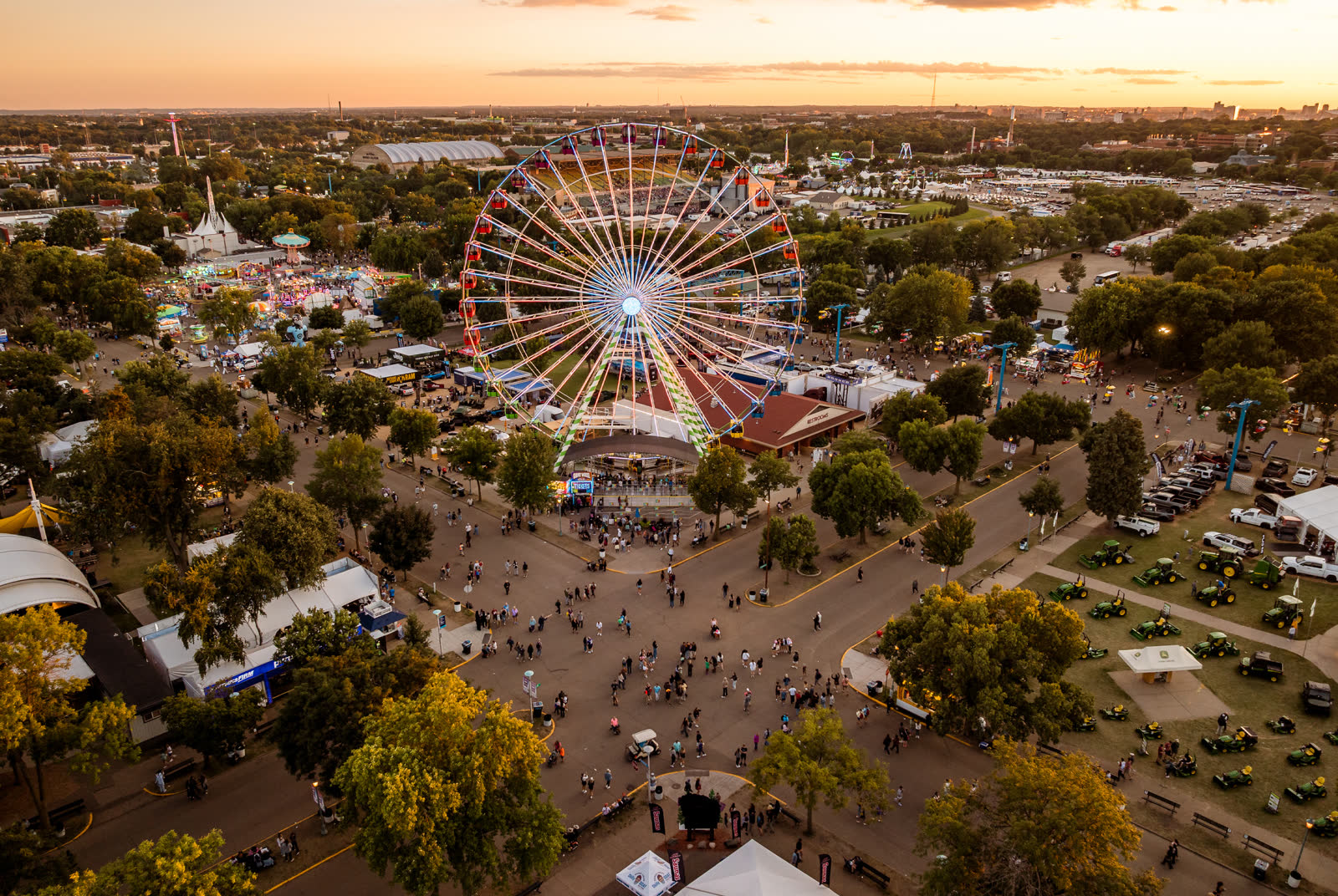 Aerial view of the Minnesota State Fairgrounds at dusk, Ferris wheel and grounds from a distance.